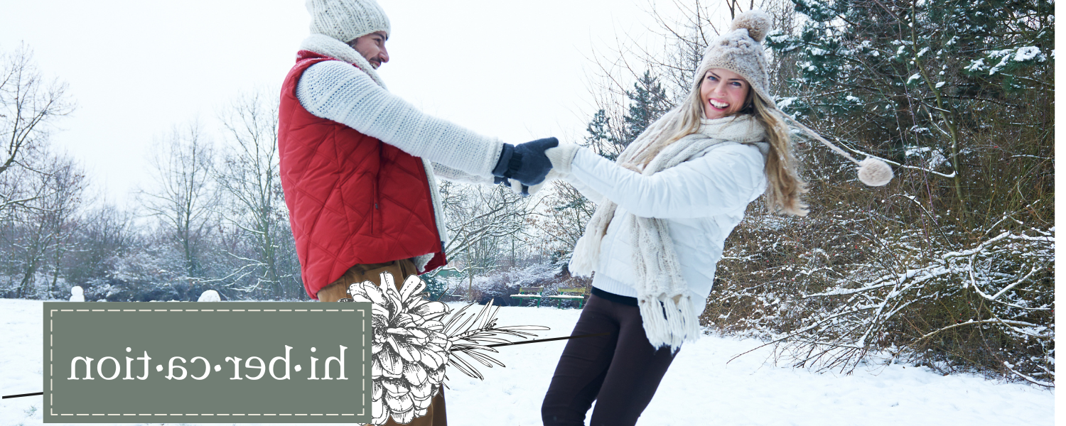 woman and man enjoying the winter outside in the snow