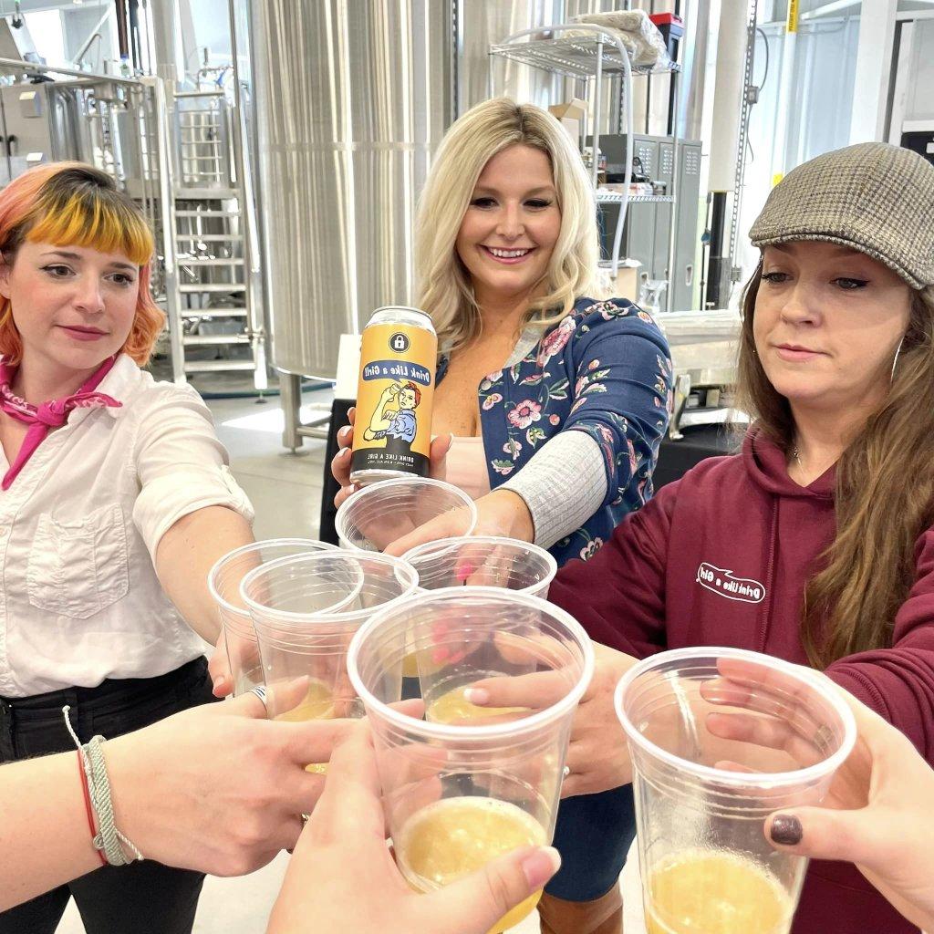 Brave Women, Brave Brews Festival showing three women toasting with cups of women brewed ale.